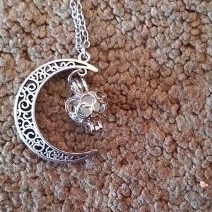 This is a silver toned Crescent Moon with a floating Heart in the middle NWOT!!